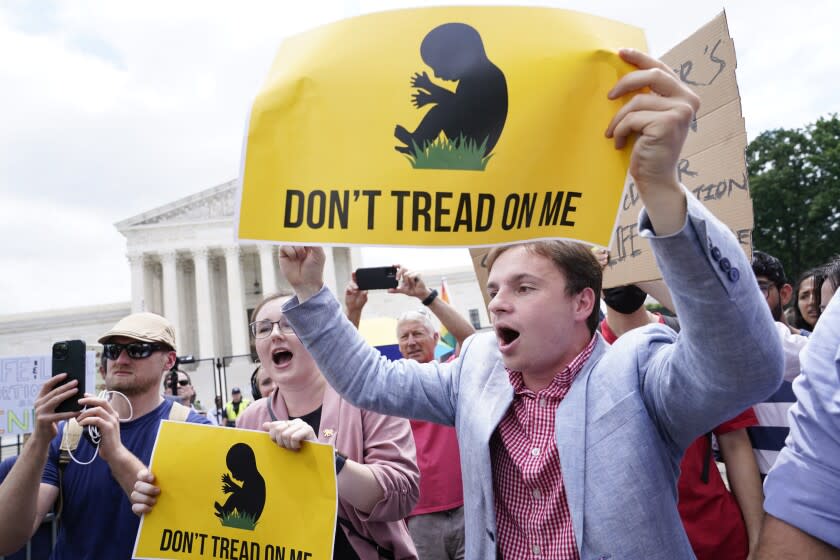 Anti-abortion activists react following Supreme Court's decision to overturn Roe v. Wade in Washington on Friday.