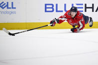 Washington Capitals left wing Beck Malenstyn reaches for the puck during the first period of an NHL hockey game against the Boston Bruins, Monday, April 15, 2024, in Washington. (AP Photo/Nick Wass)