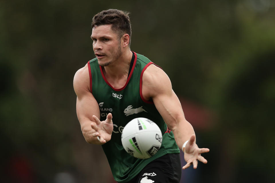 James Roberts runs and passes the ball during a South Sydney Rabbitohs NRL training session.