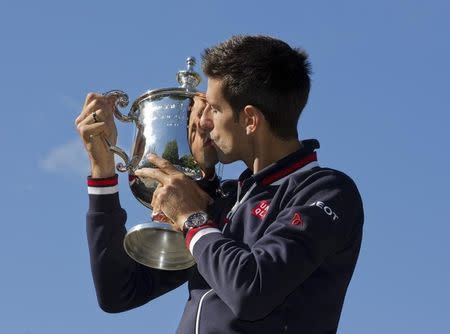 Sep 14, 2015; New York, NY, USA; Novak Djokovic of Serbia poses with the championship trophy in Central Park the day after winning the 2015 U.S. Open tennis tournament. Susan Mullane-USA TODAY Sports