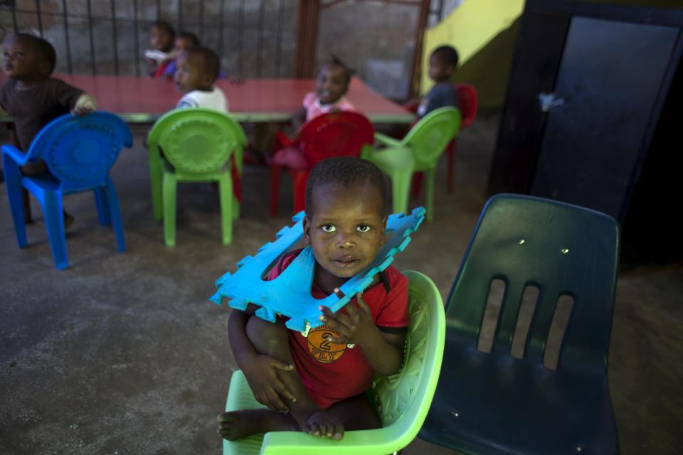 In this Feb. 1, 2014 photo, a child looks at the camera as he plays inside the orphanage run by the U.S. Church of Bible Understanding in Kenscoff, Haiti. The Church of Bible Understanding lost accreditation to run their orphanage after a series of inspections beginning in November 2012, but the government lacks the resources to shut down homes except in extreme circumstances. (AP Photo/Dieu Nalio Chery)