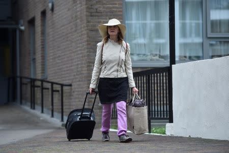 A resident is evacuated from the Taplow Tower residential block as a precautionary measure following concerns over the type of cladding used on the outside of the building on the Chalcots Estate in north London, Britain, June 24, 2017. REUTERS/Hannah McKay