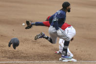 Seattle Mariners' J.P. Crawford (3) best the throw to first base as Minnesota Twins' Miguel Sano (22) reaches for he ball during the eighth inning of a baseball game, Saturday, April 10, 2021, in Minneapolis. Seattle won 4-3 in the 10 innings. (AP Photo/Stacy Bengs)