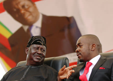 Nelson Chamisa, the new leader of Zimbabwe's Movement For Democratic Change (MDC) talks to Kenyan opposition leader Raila Odinga at the funeral of Morgan Tsvangirai in Buhera, Zimbabwe February 20, 2018. REUTERS/Philimon Bulawayo