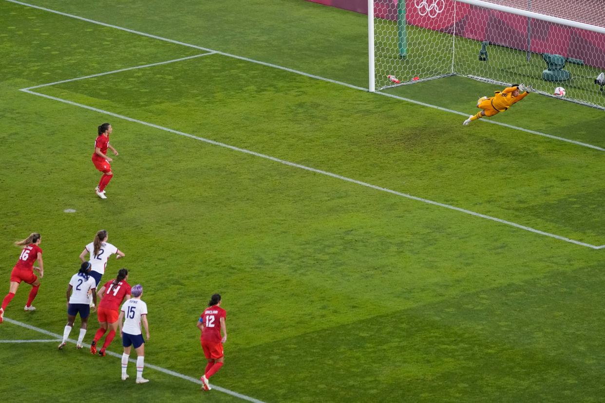 Canada's Jessie Fleming, top left, scores the opening goal from the penalty spot during a women's semifinal soccer match against the United States at the 2020 Summer Olympics, Monday, Aug. 2, 2021, in Kashima, Japan.