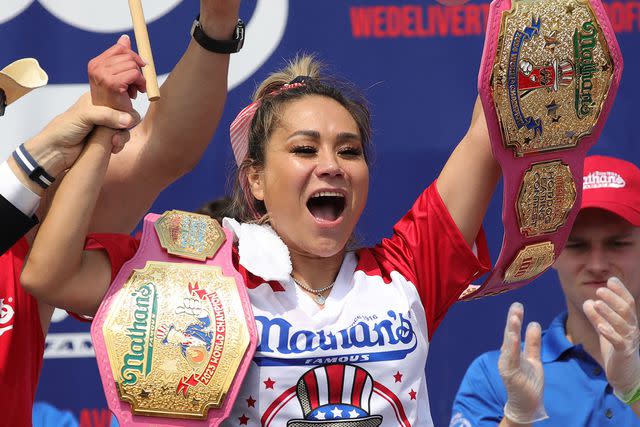 <p>LEONARDO MUNOZ/AFP via Getty</p> Miki Sudo celebrates after winning the women's title during the 2024 Nathan's Famous Fourth of July hot dog eating competition at Coney Island in the Brooklyn borough of New York on July 4, 2024.