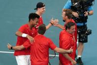 Felix Auger-Aliassime and Denis Shapovalov of Canada celebrate with their team after winning their doubles match against Germany during day 5 of the ATP Cup tennis tournament at Pat Rafter Arena in Brisbane