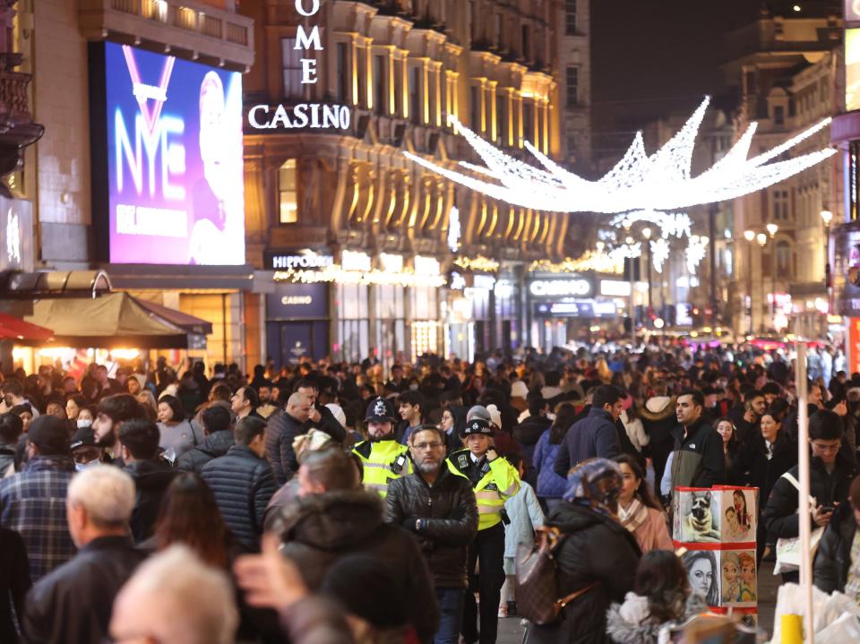 People gather in large numbers in Leicester Square, central London, to celebrate New Year's Eve (James Manning/PA)