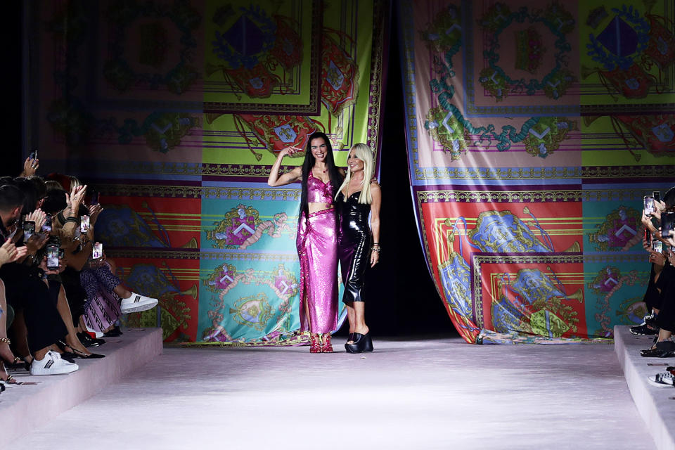 <p>Dua Lipa celebrates with fashion designer Donatella Versace after <a href="https://people.com/style/dua-lipa-makes-runway-debut-during-milan-fashion-week-alongside-gigi-hadid-and-lourdes-leon/" rel="nofollow noopener" target="_blank" data-ylk="slk:making her runway debut;elm:context_link;itc:0;sec:content-canvas" class="link ">making her runway debut</a> on Sept. 24 in Versace's spring/summer 2022 show during Milan Fashion Week in Italy.</p>