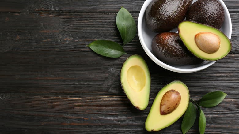 Avocados on wooden table