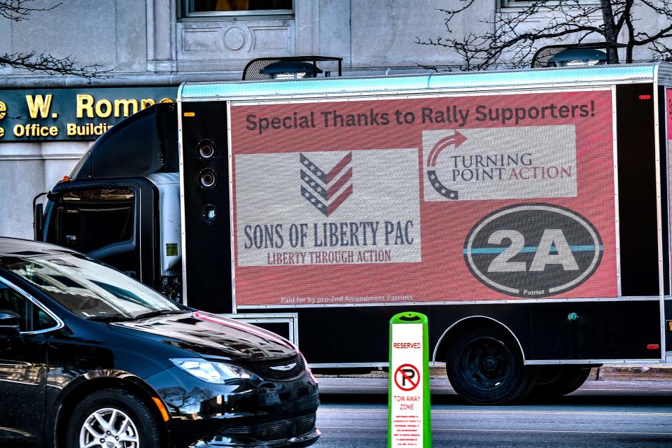 A truck with Second Amendment signage continuously circles the State Capitol during a gun violence prevention rally on March 15 in Michigan.