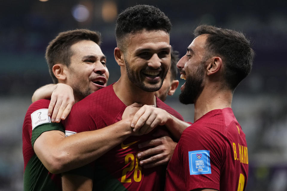 Portugal's Goncalo Ramos, center, celebrates with teammates after scoring his his side's third goal during the World Cup round of 16 soccer match between Portugal and Switzerland, at the Lusail Stadium in Lusail, Qatar, Tuesday, Dec. 6, 2022. (AP Photo/Manu Fernandez)