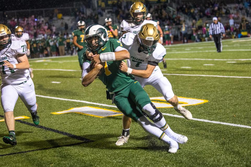 Flat Rock quarterback Graham Junge lunges for extra yards as he is brought down by St. Mary Catholic Central's Chase Terrasi during a 27-18 SMCC win Friday night.