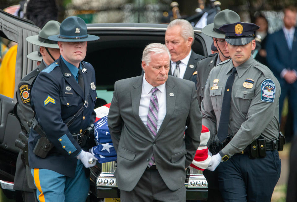 Troopers carry the casket to the gravesite of Pennsylvania State Trooper Martin Mack III.