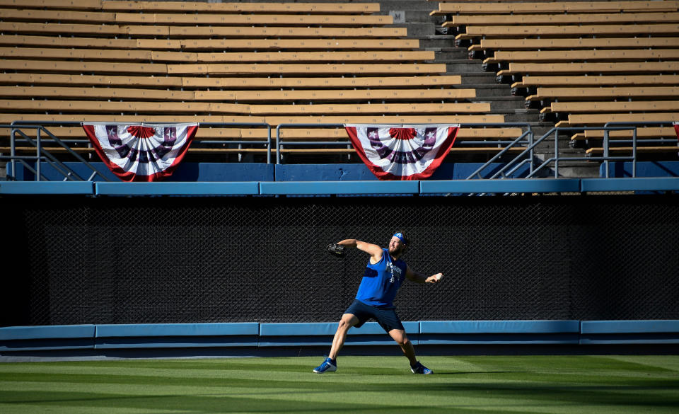 Oct 2, 2019; Los Angeles, CA, USA; Los Angeles Dodger pitcher Clayton Kershaw throws in left field in an empty stadium the day before game 1 of the National League Divisional Series against the Washington Nationals.  Mandatory Credit: Robert Hanashiro-USA TODAY Sports