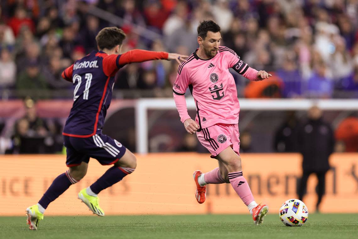 Apr 27, 2024; Foxborough, Massachusetts, USA; Inter Miami CF midfielder Lionel Messi (10) controls the ball as New England Revolution forward Nacho Gil (21) defends in the first half at Gillette Stadium. Mandatory Credit: Paul Rutherford-USA TODAY Sports