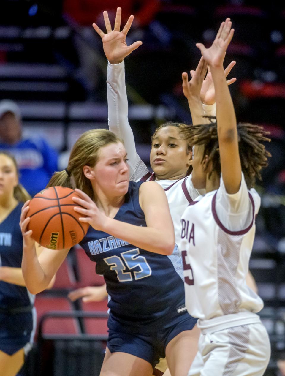 Peoria High's Aaliyah Guyton, middle, and Danielle Ruffin, right, pressure Nazareth Academy's Amalia Dray in the second half of the Class 3A state semifinals Friday, March 3, 2023 at CEFCU Arena in Normal. The Lions ultimately fell to the Roadrunners 48-35.