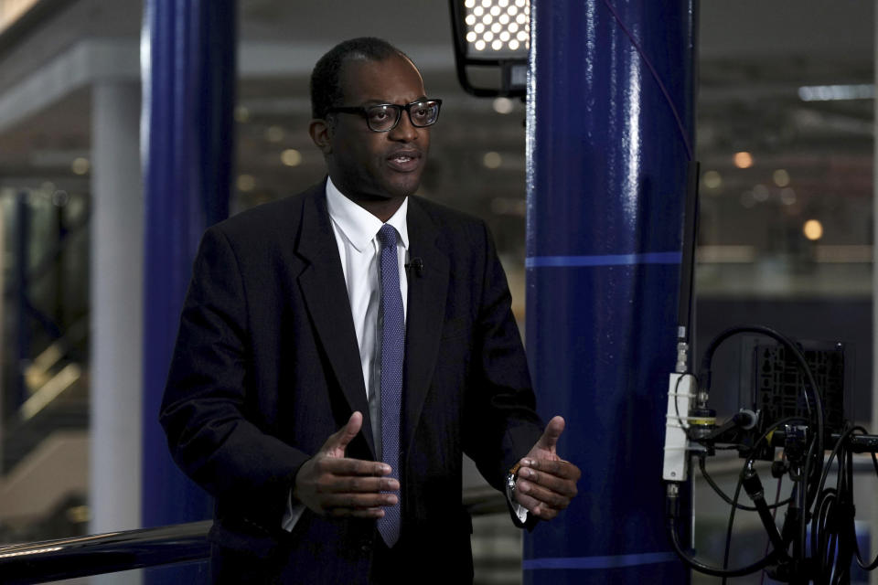 Britain's Chancellor of the Exchequer Kwasi Kwarteng speaks to the media ahead of the Conservative Party annual conference at the International Convention Centre in Birmingham, England, Monday, Oct. 3, 2022. The British government has dropped plans to cut income tax for top earners, part of a package of unfunded cuts that sparked turmoil on financial markets and sent the pound to record lows. (Aaron Chown/PA via AP)