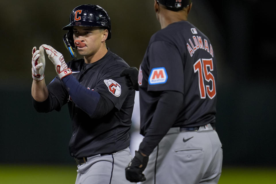 Cleveland Guardians' Will Brennan, left, reacts after hitting an RBI single against the Oakland Athletics during the fifth inning of a baseball game Friday, March 29, 2024, in Oakland, Calif. (AP Photo/Godofredo A. Vásquez)