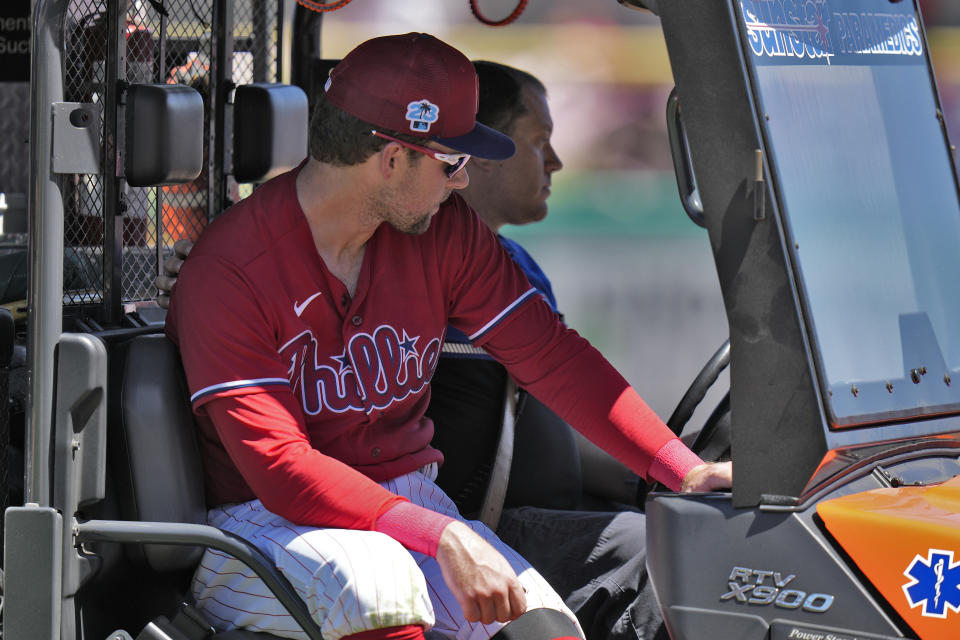Philadelphia Phillies first baseman Rhys Hoskins is taken off the field after getting injured fielding a ground ball by Detroit Tigers' Austin Meadows during the second inning of a spring training baseball game Thursday, March 23, 2023, in Clearwater, Fla. (AP Photo/Chris O'Meara)