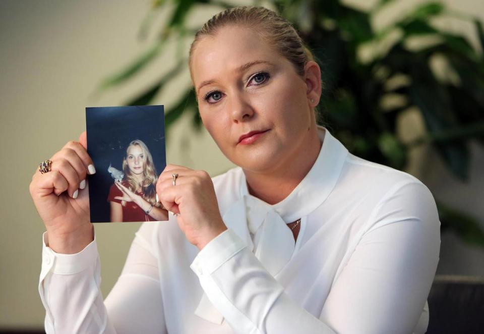 Virginia Roberts Giuffre, with a photo of herself as a teen — when she says she was abused by Jeffrey Epstein, Ghislaine Maxwell and Prince Andrew, among others.