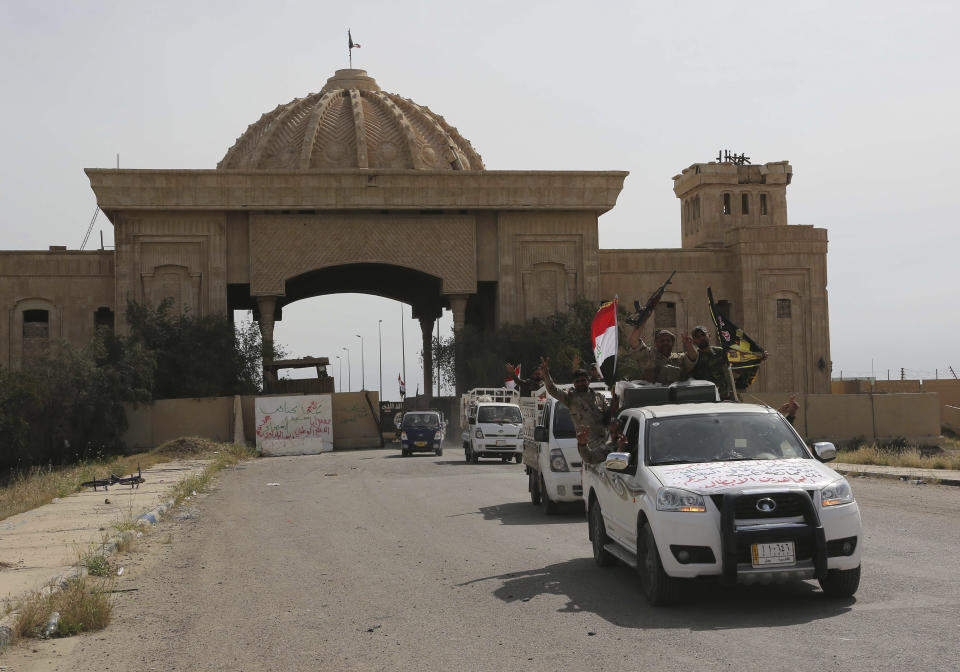Shiite militiamen celebrate at one of Saddam Hussein's palaces in Tikrit, 80 miles  north of Baghdad, Iraq, Friday, April 3, 2015. (AP Photo/Khalid Mohammed)