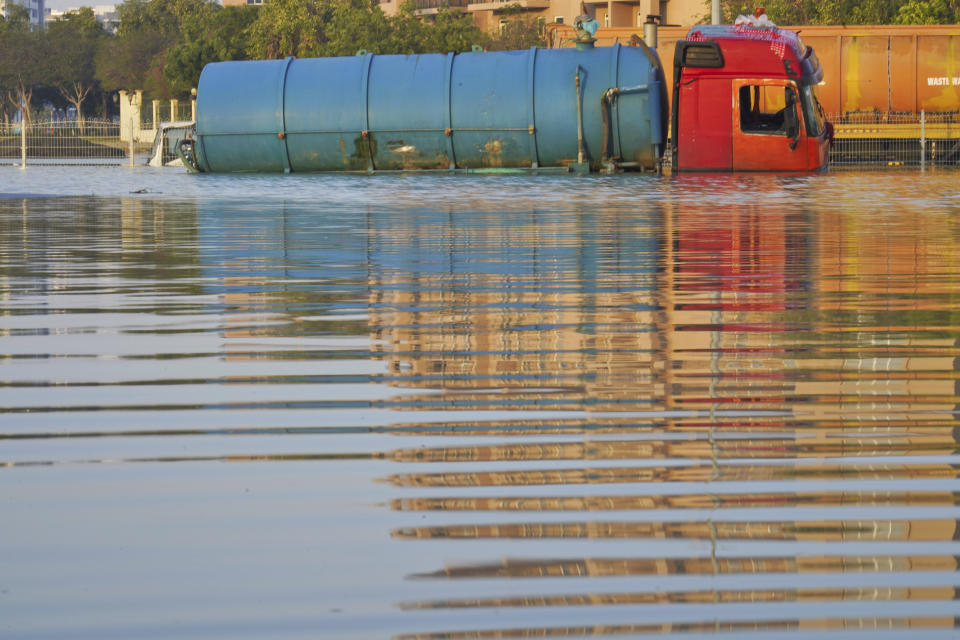 A tanker truck sits abandoned in floodwaters in Dubai, United Arab Emirates, April 18, 2024. The United Arab Emirates attempted to dry out from the heaviest rain the desert nation has ever recorded, a deluge that flooded out Dubai International Airport and disrupted flights through the world's busiest airfield for international travel. (AP Photo/Jon Gambrell)