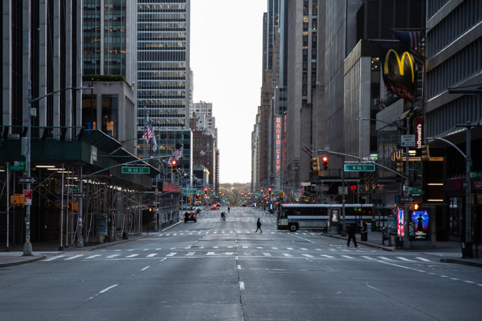 Pedestrians walk along a nearly empty street in Manhattan. Source: Getty