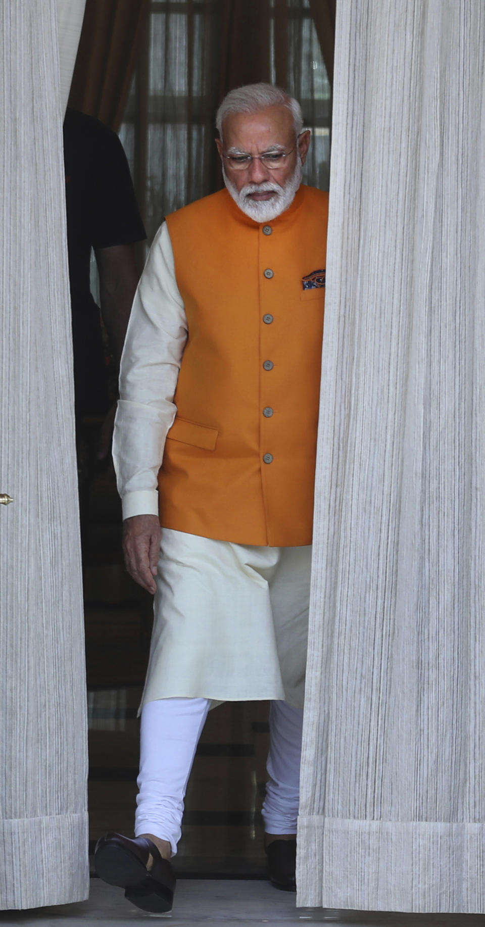 Indian Prime Minister Narendra Modi leaves to receive one of the leaders from a neighboring country for a bilateral meeting in New Delhi, India, Friday, May 31, 2019. India's newly sworn in Prime Minister Narendra Modi named a Cabinet on Friday, handing the powerful home affairs portfolio to the president of his Hindu nationalist party credited with delivering him a thunderous reelection and appointing a former diplomat to signal the government's focus on foreign policy. (AP Photo/Manish Swarup)