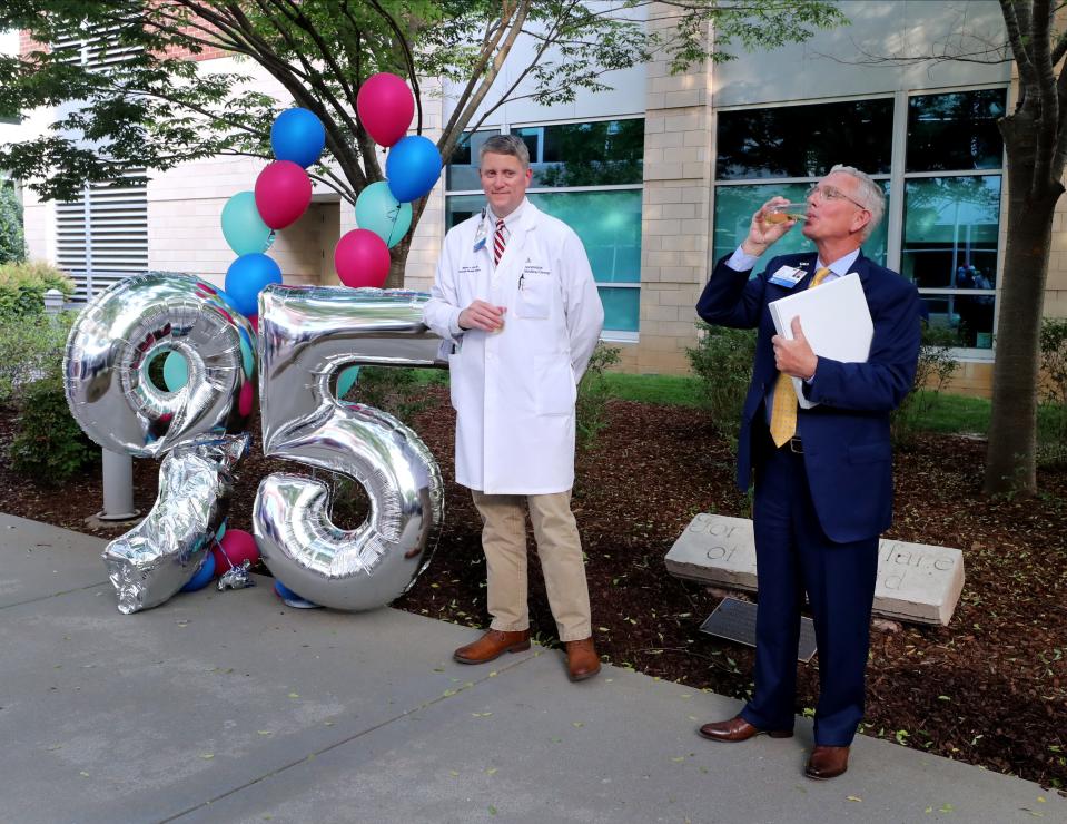 Ascension Saint Thomas Rutherford Hospital Chief of Staff Dr. Stephen A. Rich, left, and Gordon B. Ferguson, the President & CEO, present a toast during a 95th anniversary celebration hospital on Monday, May 2, 2022.