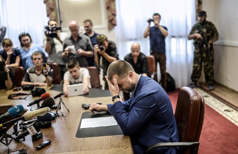 Self-proclaimed Prime Minister of the pro-Russian separatist "Donetsk People's Republic", Alexander Borodai (C), gives a press-conference in the eastern Ukrainian city of Donetsk, on July 19, 2014