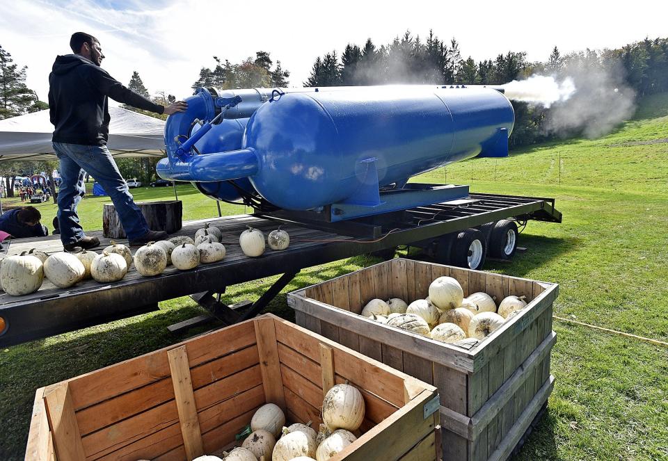 Seth Eliason, of Greene Township, fires a pumpkin cannon during Fall Fest on Oct. 8, 2017, at Peek'n Peak Resort near Findley Lake, N.Y.