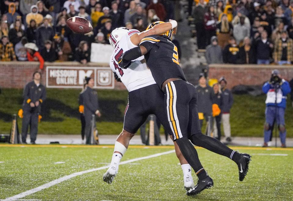 South Carolina quarterback Jason Brown (15) is hit by Missouri defensive back Martez Manuel (3) while throwing during a game at Faurot Field.