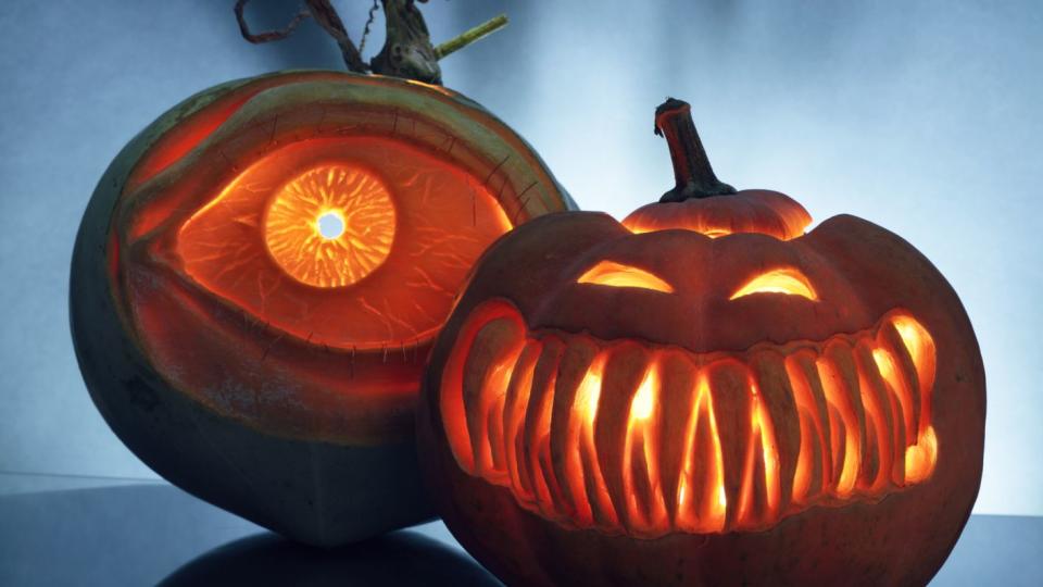 two artistically carved jack o lantern pumpkins