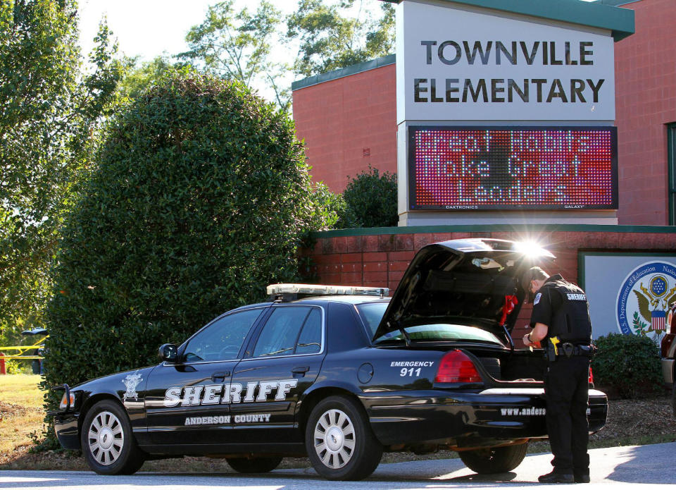 <p>An Anderson County sheriff’s deputy stands outside of Townville Elementary School after a shooting in Townville, S.C., on Sept. 28, 2016. (Nathan Gray/Reuters). </p>