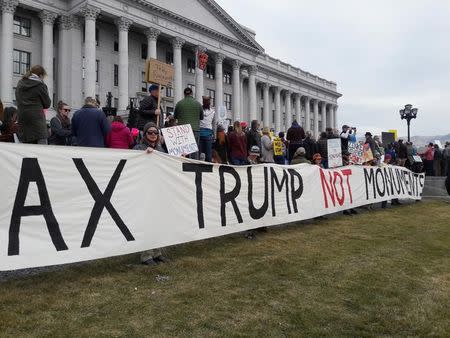 Protesters carry signs December 2, 2017 at a rally in Salt Lake City, Utah, U.S. against plans by President Donald Trump to shrink the size of two national monuments areas in the state, which would open them up for development including mining and drilling. REUTERS/Emily Means