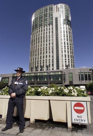 A security guard keeps vigil outside the Crown Towers hotel, retail, food and casino complex at Southbank near Melbourne's city centre, in this file picture taken September 9, 2000. REUTERS/Will Burgess/Files