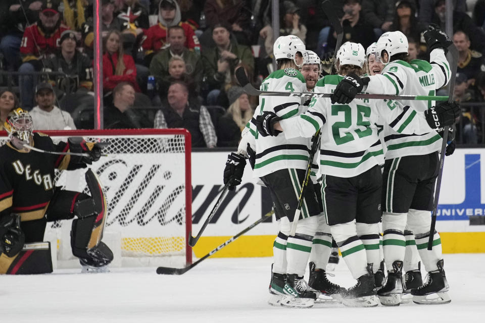 Dallas Stars celebrate after left wing Joel Kiviranta (25) scored against the Vegas Golden Knights during the second period of an NHL hockey game Monday, Jan. 16, 2023, in Las Vegas. (AP Photo/John Locher)