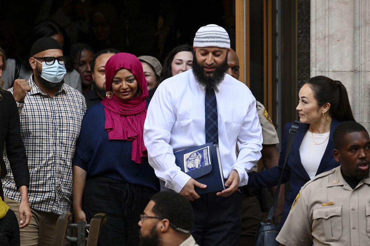 Adnan Syed, center right, leaves the courthouse after the hearing, Monday, Sept. 19, 2022, in Baltimore.