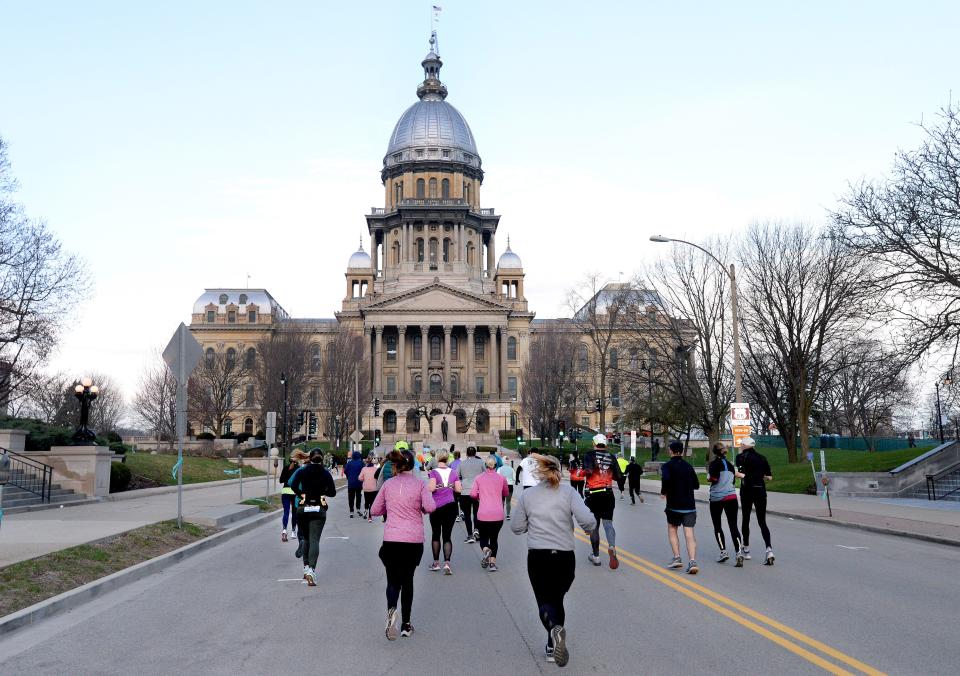 Runners head down Capitol Ave. during the Lincoln Presidential Half Marathon Saturday April 2, 2022. [Thomas J. Turney/The State Journal-Register]