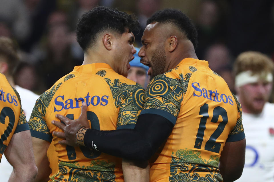 Australia's Samu Kerevi, right, celebrates scoring a try with teammate Australia's Noah Lolesio during their rugby union match against England in Brisbane, Australia, Saturday, July 9, 2022. (AP Photo/Tertius Pickard)