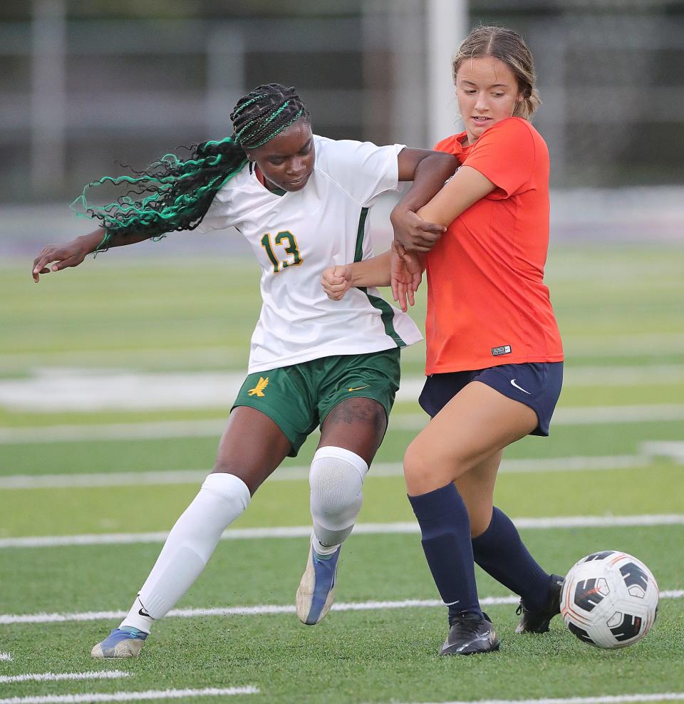 Firestone's Chatasia Davis gets tangled with Ellet's Olivia McCoy on Wednesday, Sept. 21, 2022 in Akron.