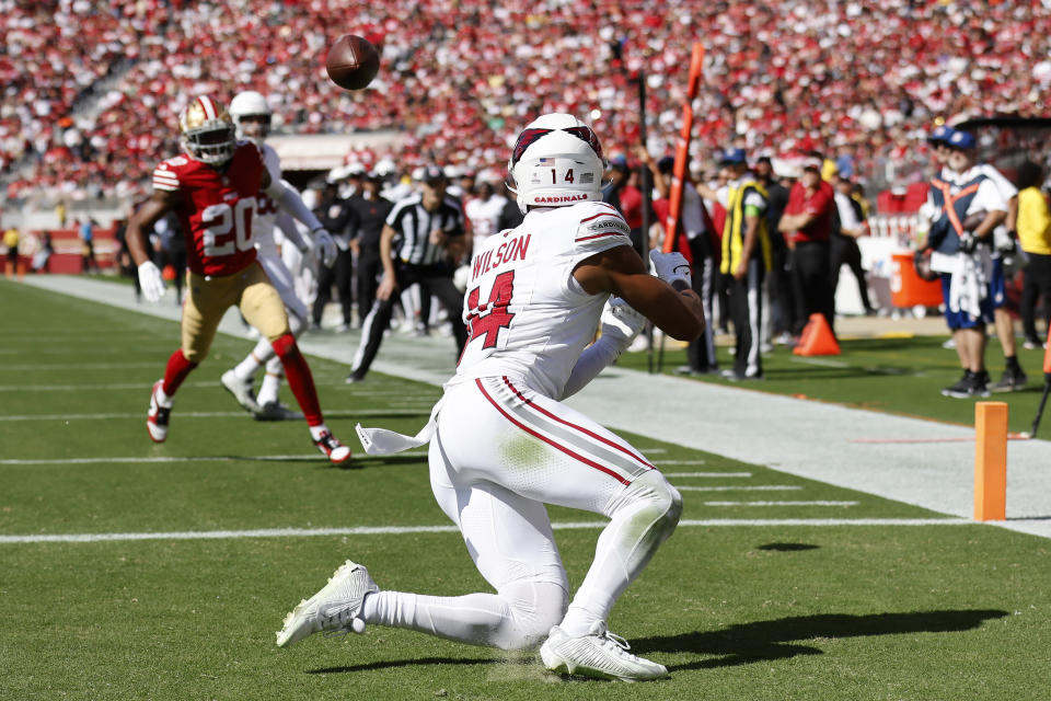 Arizona Cardinals wide receiver Michael Wilson (14) catches a touchdown pass in front of San Francisco 49ers cornerback Ambry Thomas (20) during the first half of an NFL football game in Santa Clara, Calif., Sunday, Oct. 1, 2023. (AP Photo/Josie Lepe)