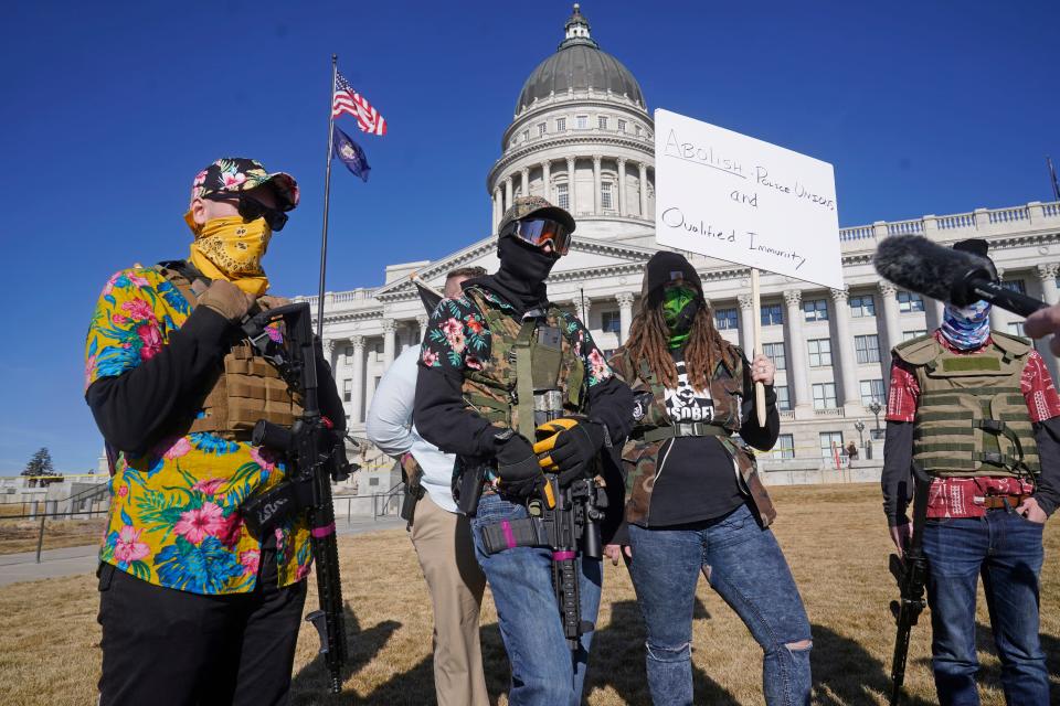 Armed protesters gather at the Utah State Capitol Sunday, Jan. 17, 2021, in Salt Lake City.