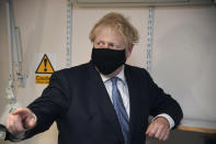 Britain's Prime Minister Boris Johnson gestures during a visit to Tollgate Medical Centre in Beckton, East London, Friday July 24, 2020. (Jeremy Selwyn/Pool Photo via AP)