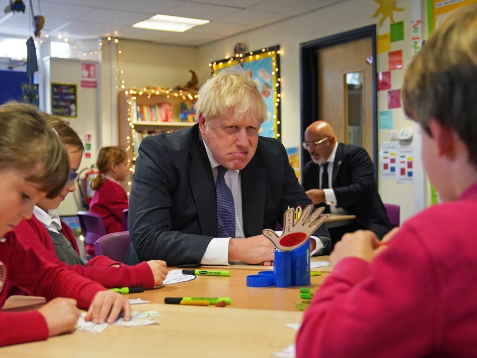 Boris Johnson pulls facial expressions while interacting with school children during a visit to Westbury-On-Trym Church of England Academy in Bristol (PA)