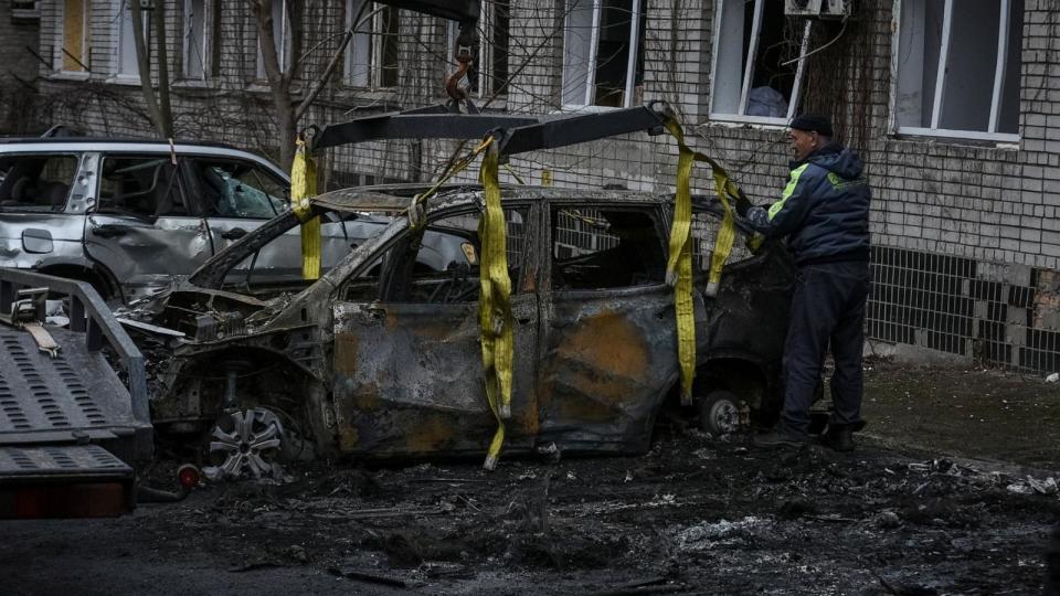 PHOTO: A communal worker prepares a damaged car to be towed, near a residential building damaged during a Russian drone strike, amid Russia's attack on Ukraine, in Dnipro, Ukraine Jan. 7, 2024. (Stringer/Reuters)