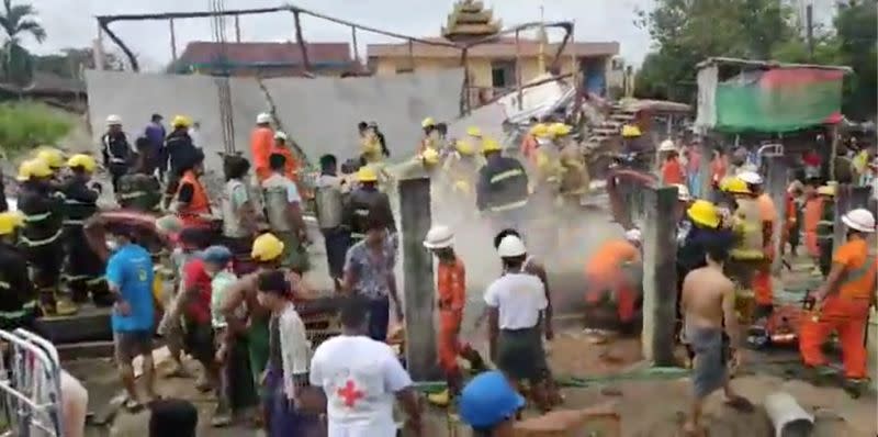 Myanmar Fire Services Department personnel clears debris after a construction building collapsed in East Dagon Township, Yangon