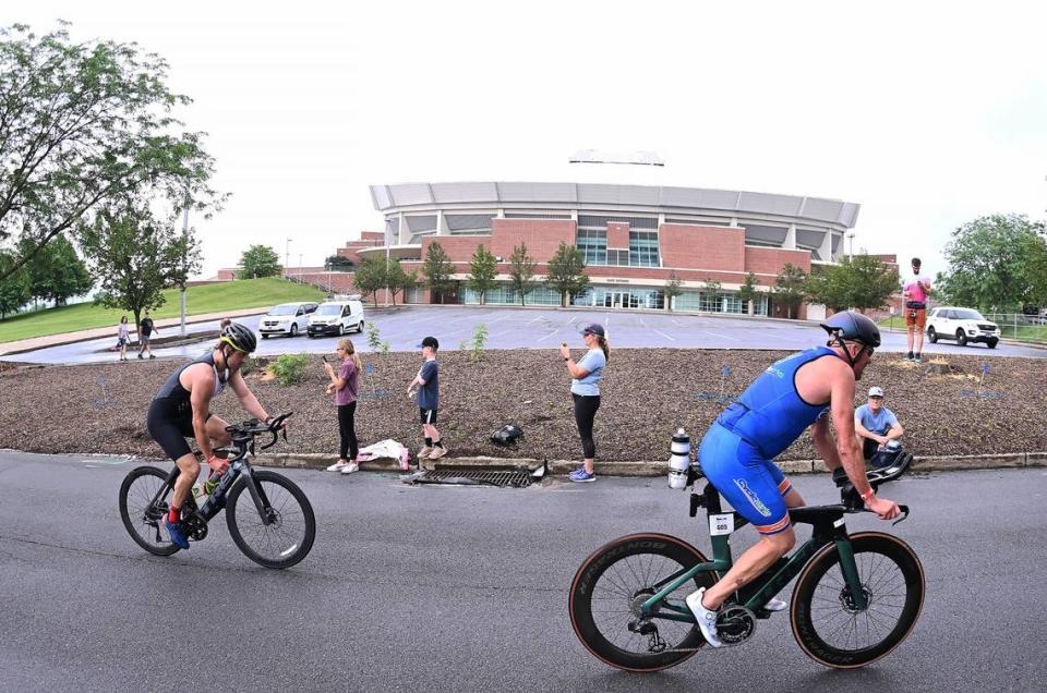 Participants in the Ironman 70.3 Pennsylvania Happy Valley finish the bike portion outside the Bryce Jordan Center Sunday, July 2, 2023.