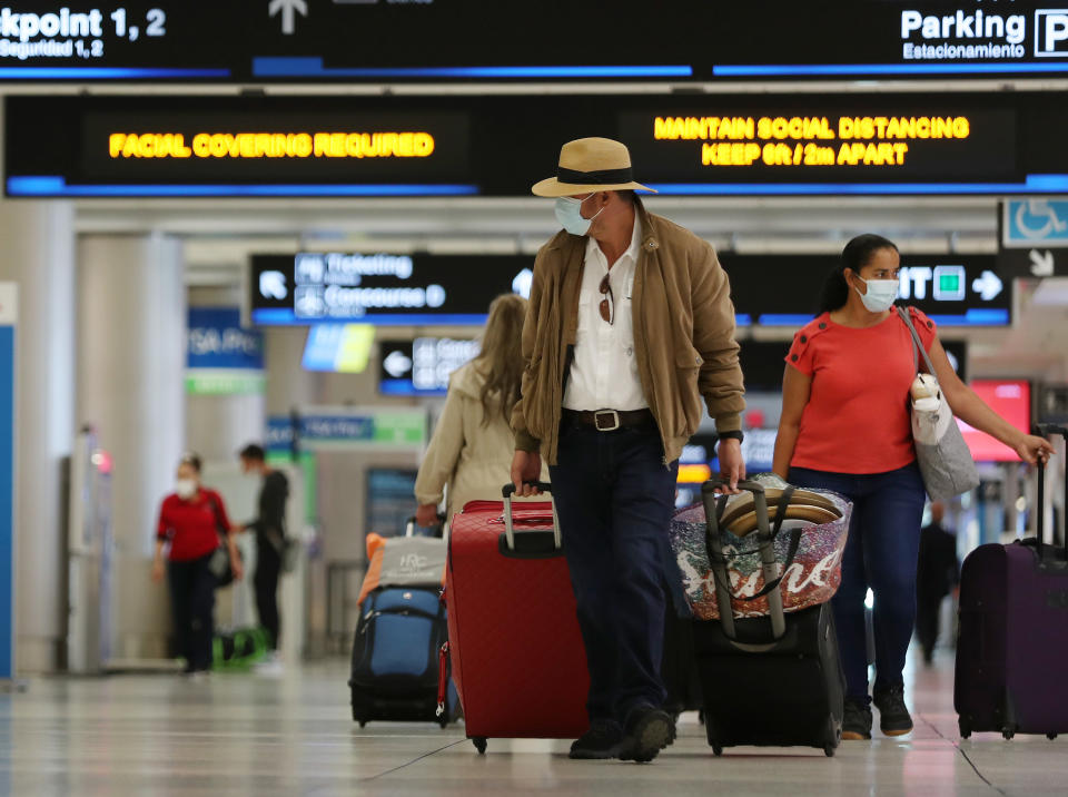 Travelers walk through Miami International Airport on February 01, 2021 in Miami, Florida. (Joe Raedle/Getty Images)